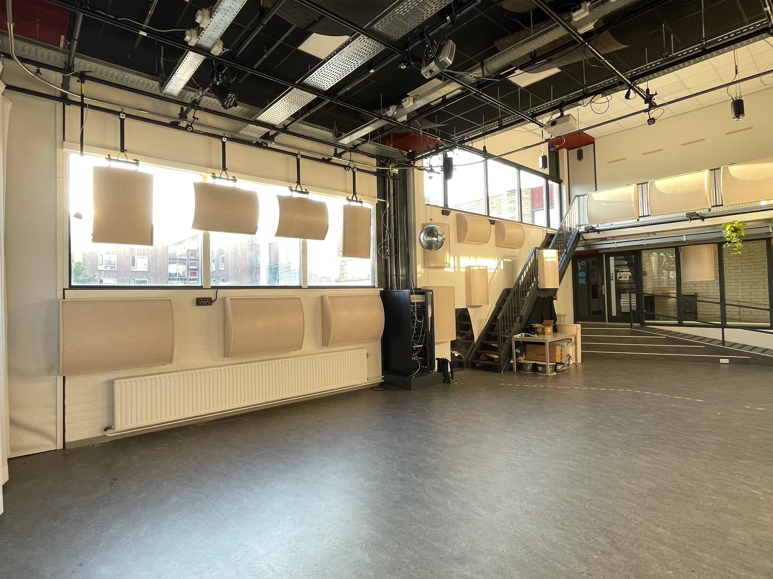 curved acoustic panels hung along the windows and walls of the hku blackbox